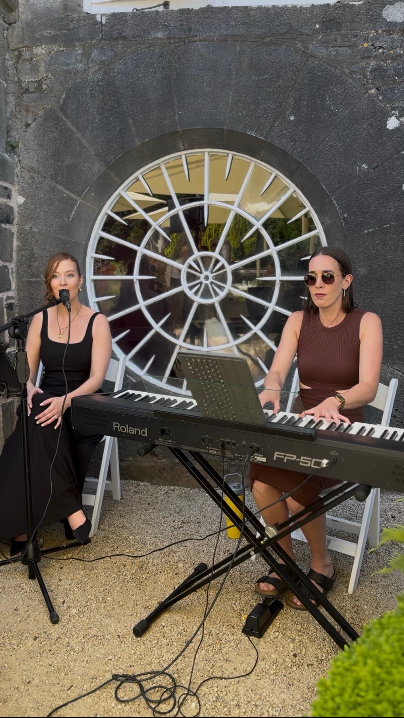 Saoirse and a duo performing at a wedding venue